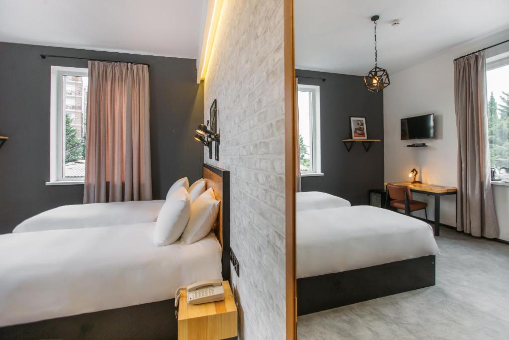 Postel nebo postele na pokoji v ubytování Timber Boutique Hotel