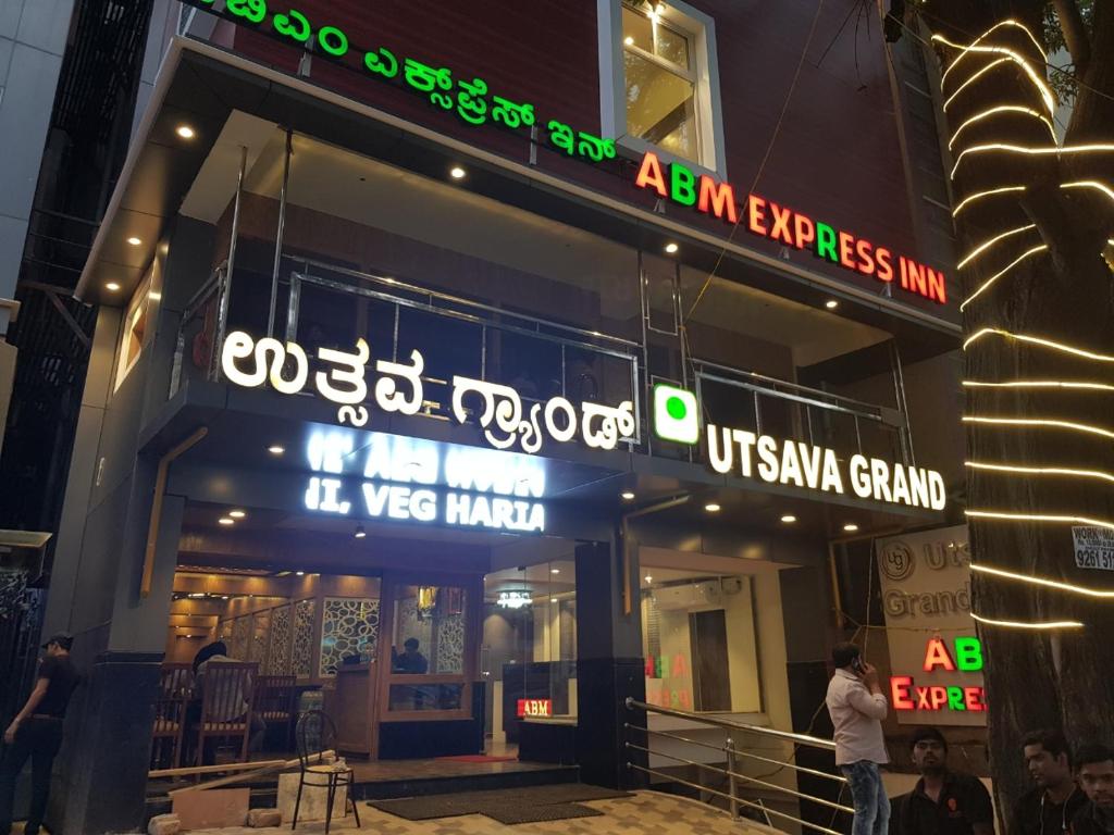 a building with neon signs on the front of it at ABM Express Inn in Bangalore