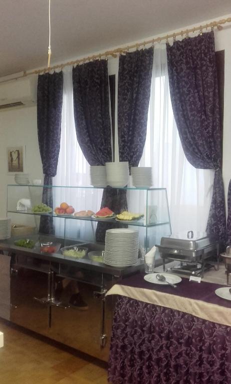 a buffet in a room with purple curtains at Resort Village T.N. Milna in Vis
