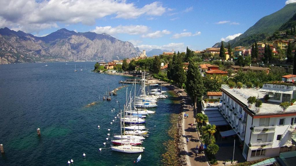 a group of boats are docked in a river at Hotel Excelsior Bay in Malcesine
