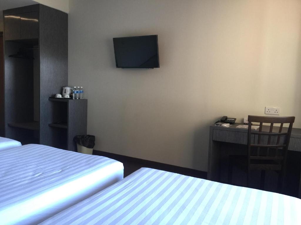 Postel nebo postele na pokoji v ubytování Check Inn Hotel Tawau