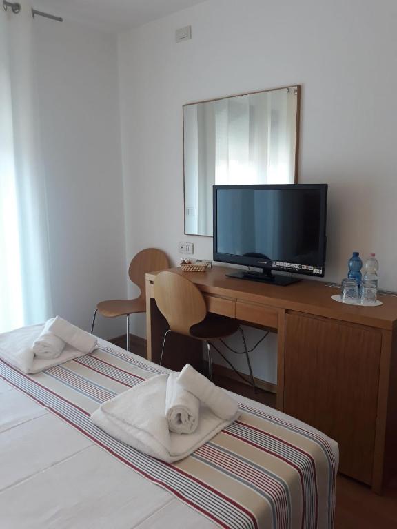Postel nebo postele na pokoji v ubytování Lacroma Bio Hotel & Apartments