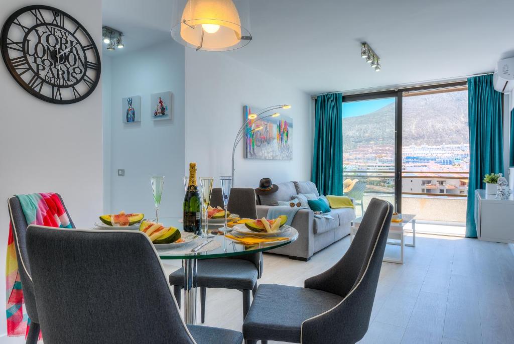 a living room with a table and chairs and a couch at Modern Apartment Los Cristianos Center in Los Cristianos