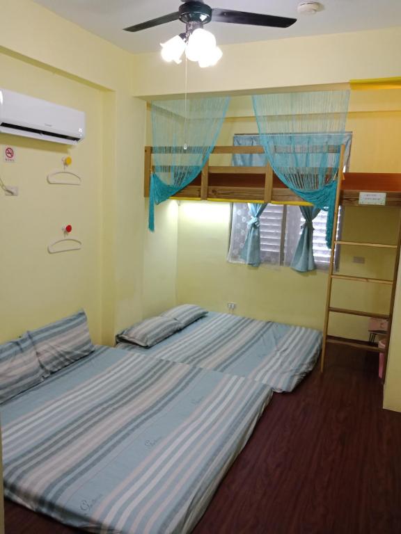 Postel nebo postele na pokoji v ubytování Ludao B&B