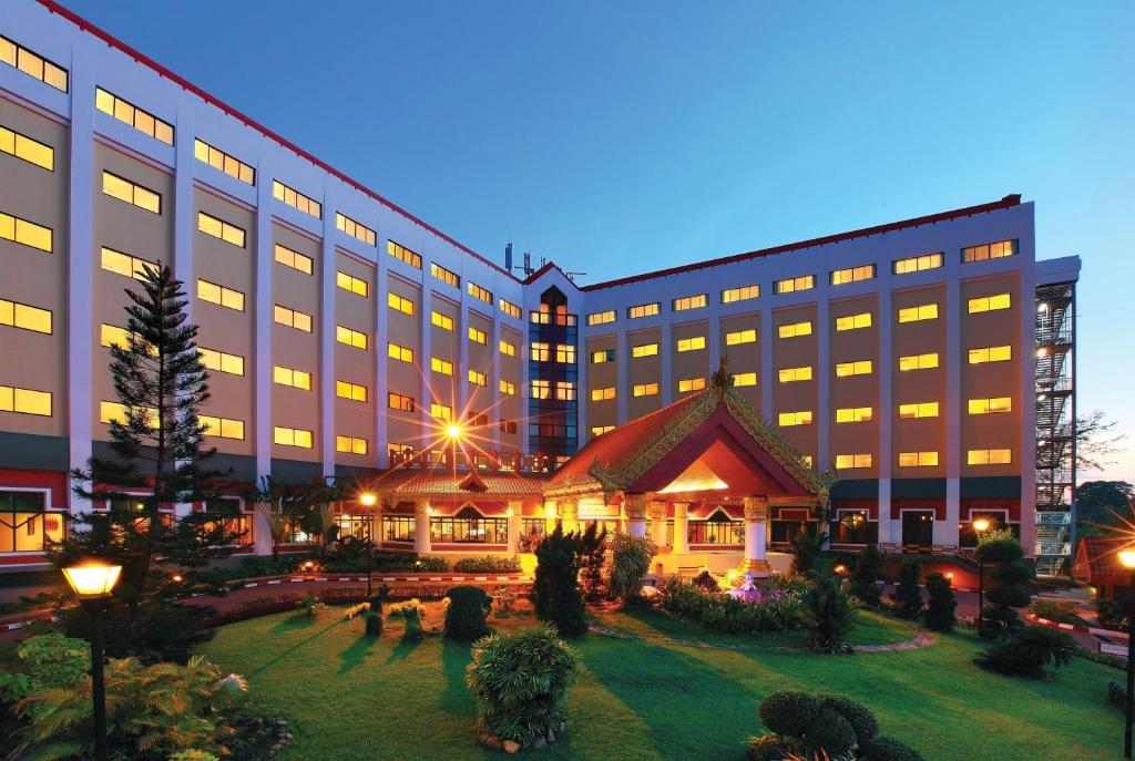 a hotel with a large building with a garden at Summit Parkview Yangon in Yangon