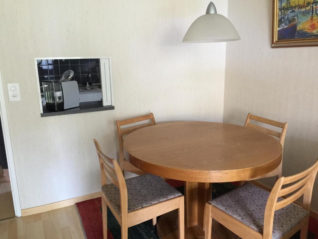 a dining room table with four chairs and a mirror at Barga GP in Davos