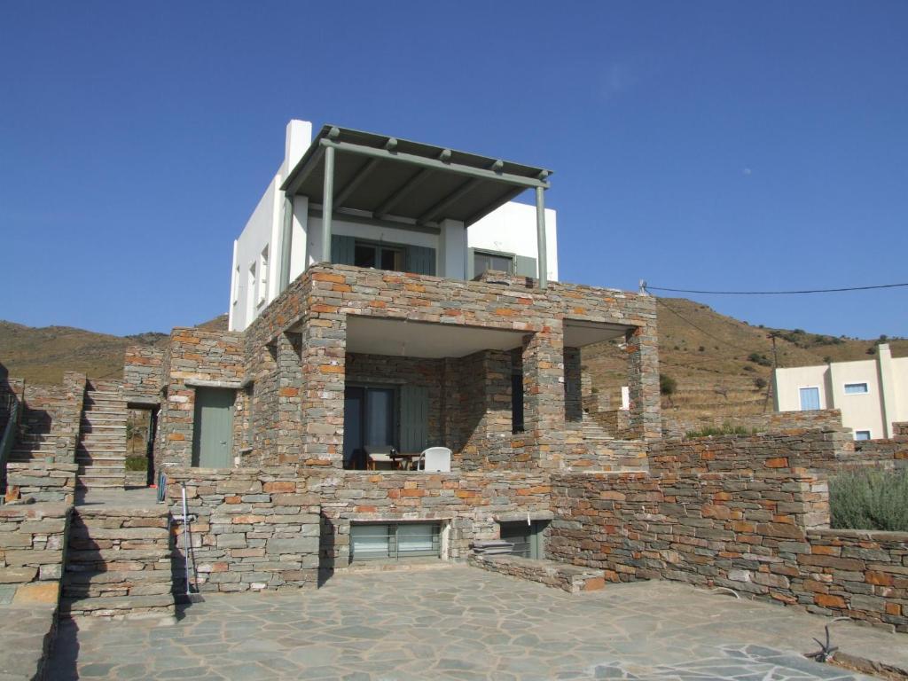 a brick building with a balcony on top of it at Unique studio by the sea in Koundouros