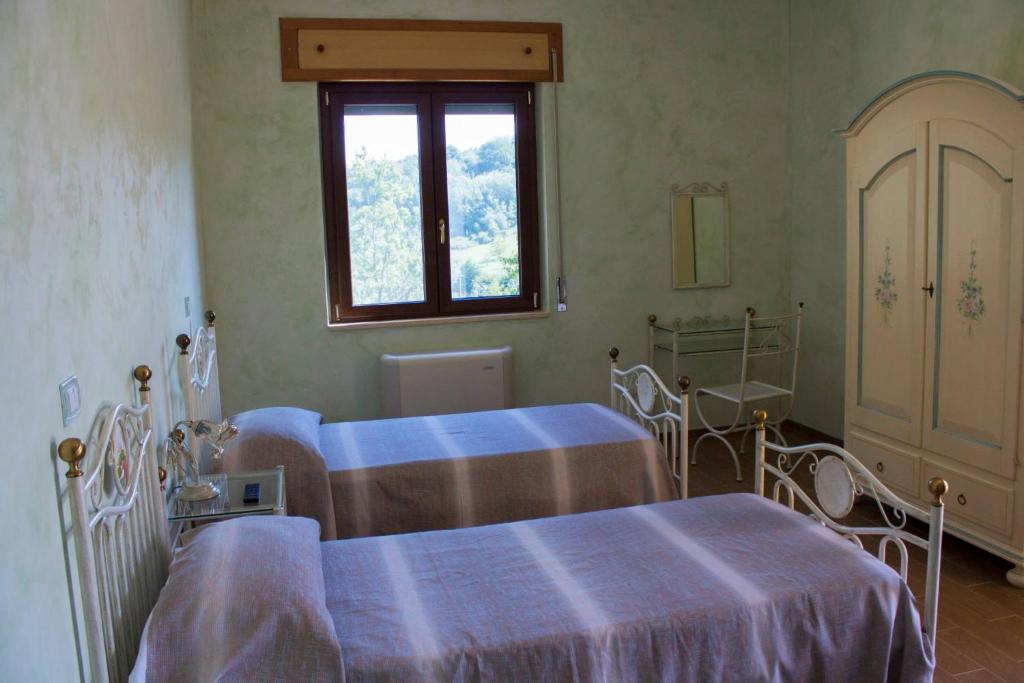 Postel nebo postele na pokoji v ubytování Agriturismo La Turritella