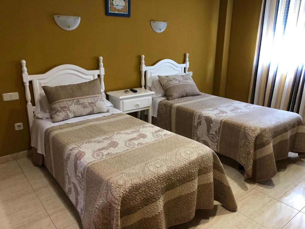 Postel nebo postele na pokoji v ubytování Hostal 82