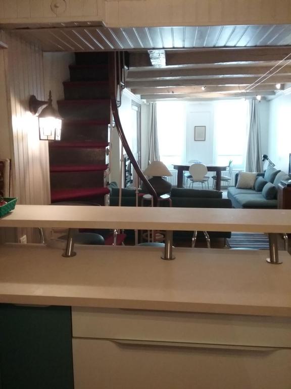 a living room with a couch and a staircase at 81 Rue des Juifs in Granville