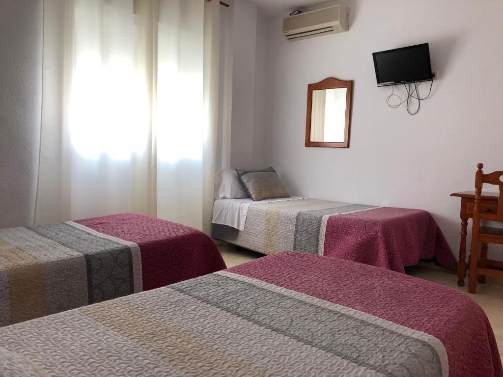 Postel nebo postele na pokoji v ubytování Hostal 82
