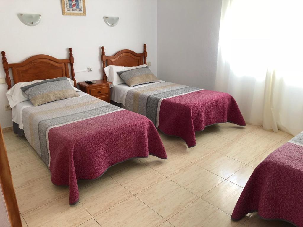 Postel nebo postele na pokoji v ubytování Hostal 82