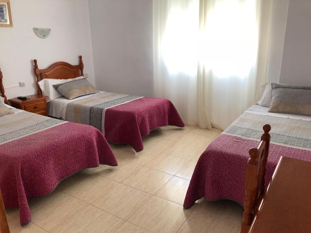 Postel nebo postele na pokoji v ubytování Hostal 82