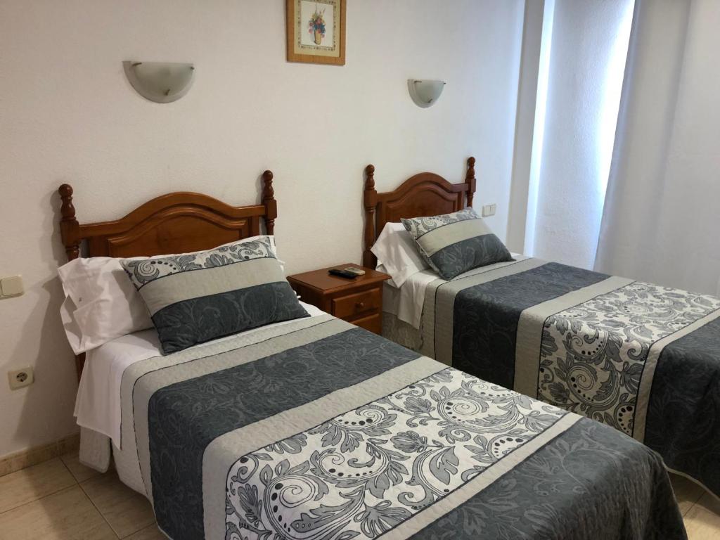 Postel nebo postele na pokoji v ubytování Hostal 82