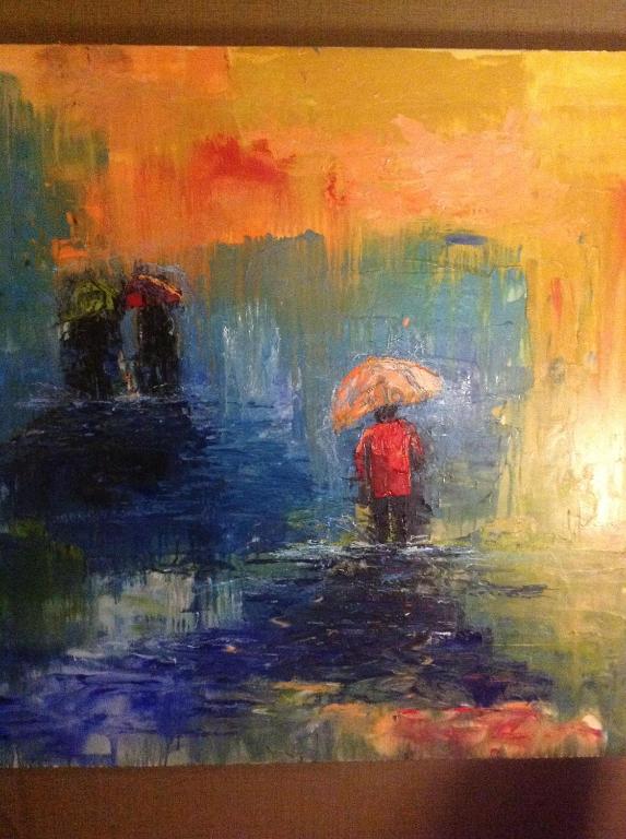 a painting of a person walking in the rain with an umbrella at Hotel Arts Kensington in Calgary