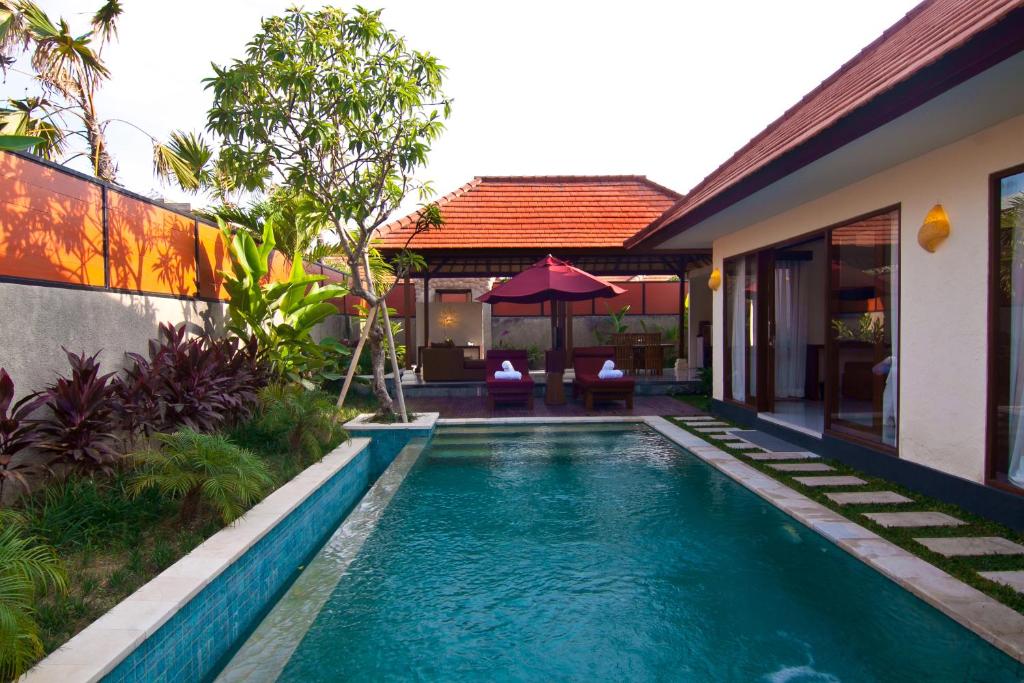 a swimming pool in the backyard of a villa at The Awan Villas - CHSE Certified in Seminyak