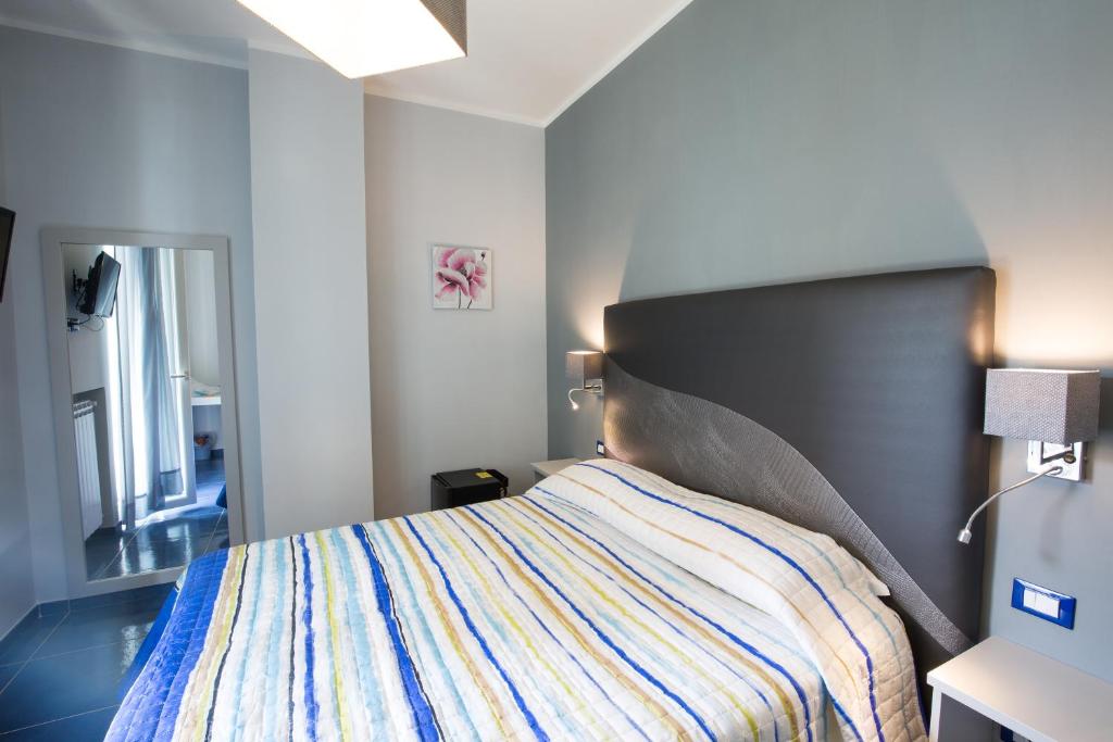 a bedroom with a bed with a large headboard at Residenza Sole Maiori in Maiori