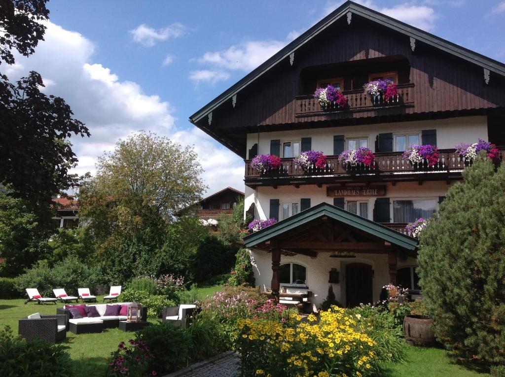 a building with a balcony with flowers on it at Landhaus Ertle in Bad Wiessee