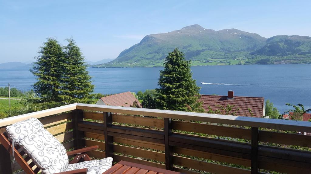 a bench on a balcony with a view of the water at Holiday Home Kvernesfjorden in Averoy