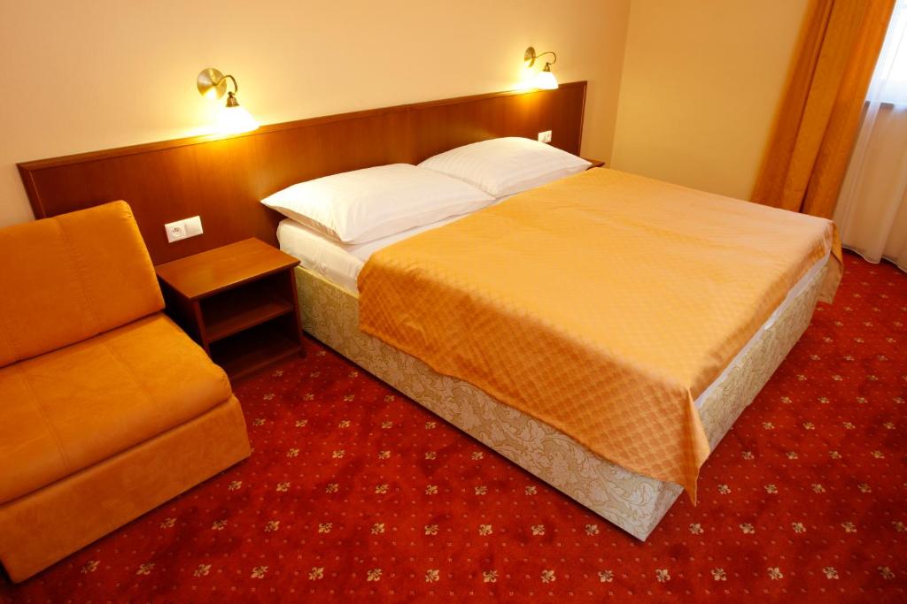 Posteľ alebo postele v izbe v ubytovaní Hotel Majolika