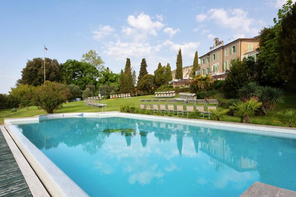 a large swimming pool in front of a building at Hotel Du Parc in Garda