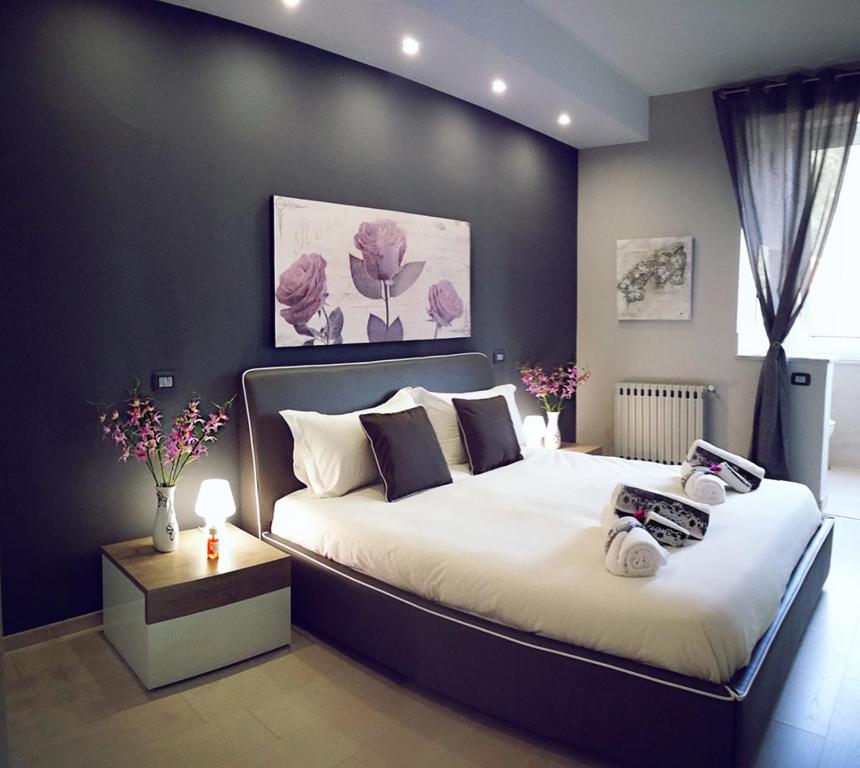 a bedroom with a large bed with a black wall at La Casa del Sole in Cinisi