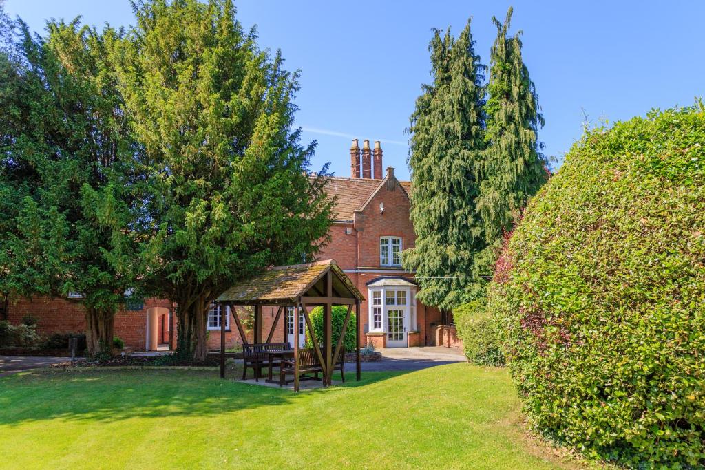 a house with a gazebo in the yard at The Charlecote Pheasant in Stratford-upon-Avon