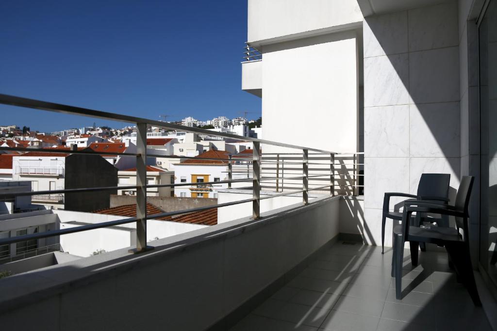 a balcony with a view of a city at Hotel Praia in Nazaré