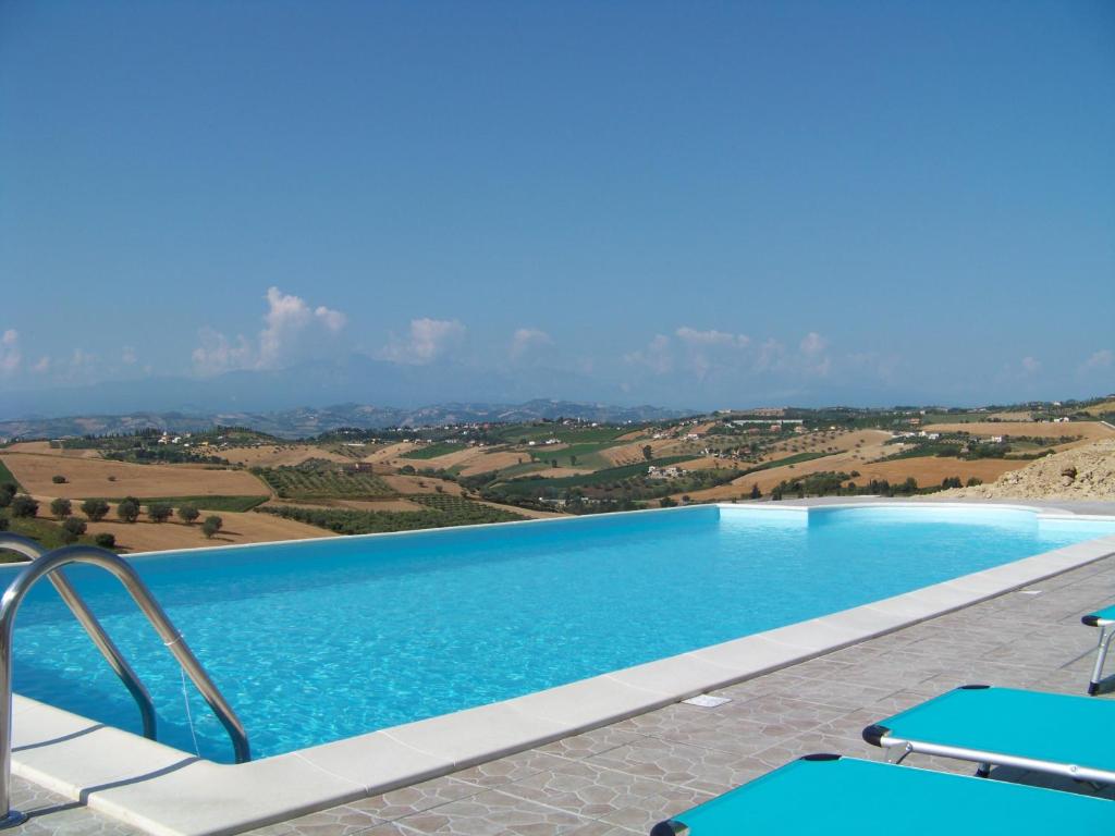 a swimming pool with a view of the countryside at casa cologna glamping in Cologna