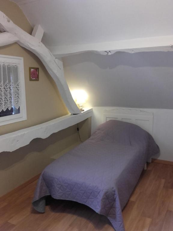 a bedroom with a bed and a book shelf at Chambre d&#39;hôtes La Guéjaillière in Beaumont-Pied-de-Boeuf