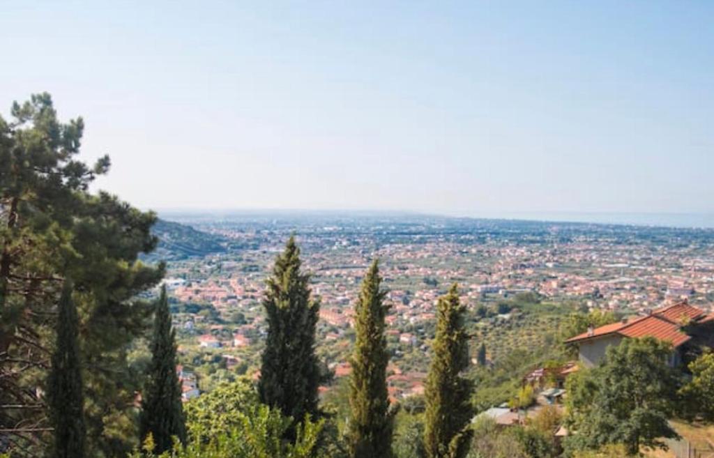 a view of a city from a hill with trees at Casa Rosa in collina in Pietrasanta