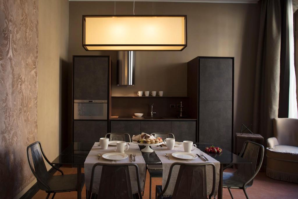 un comedor con una mesa con sillas y una luz en Aqua Apartments, en Venecia