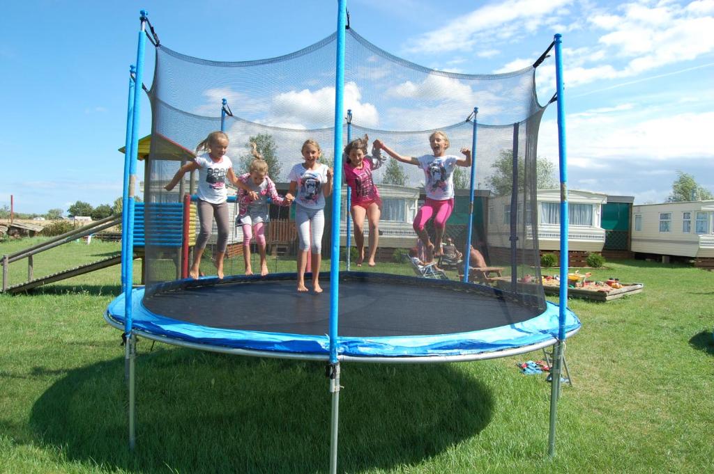 a group of children standing on a trampoline at Rodzinna Przystań in Jarosławiec