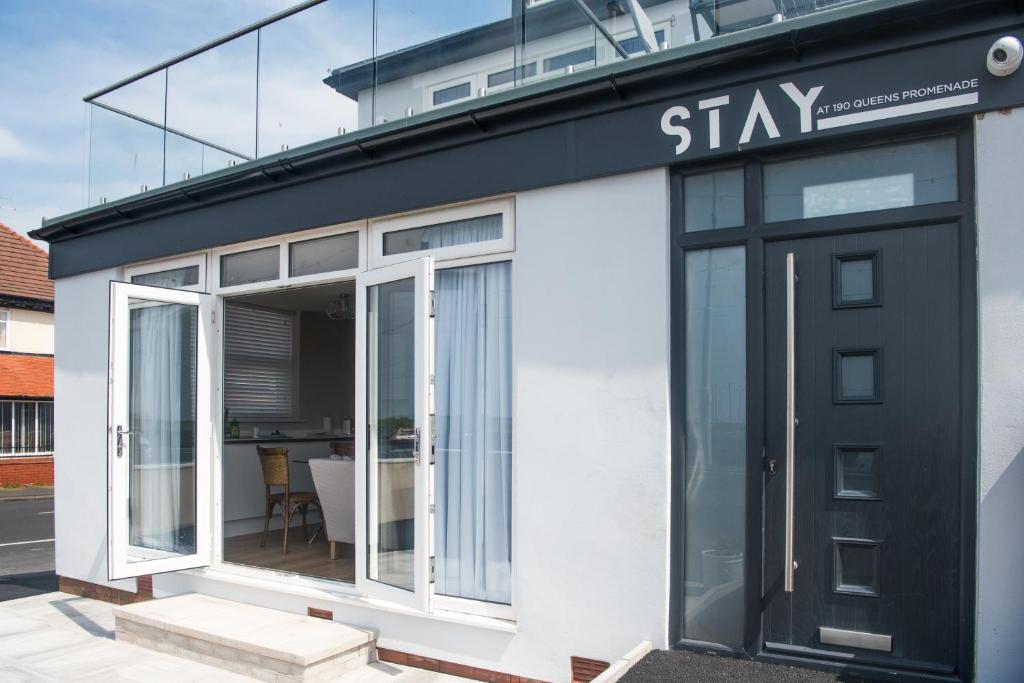 a black and white building with glass doors at Stay in Blackpool