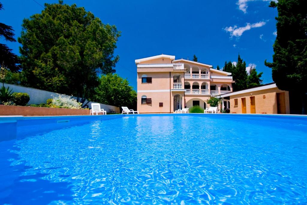 a large swimming pool in front of a house at Sun Palace Residence in Premantura