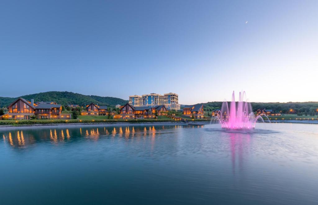 a pink fountain in the middle of a lake at Quba Palace Hotel & Golf Resort in Quba