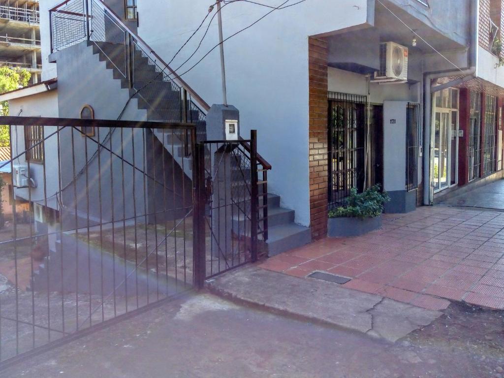 a gate in front of a building with a staircase at Alvar Nuñez in Puerto Iguazú