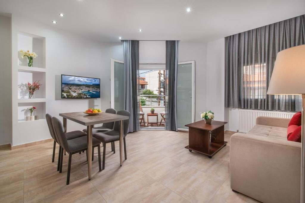 a living room with a table and a couch at Kamis Suite in Neos Marmaras