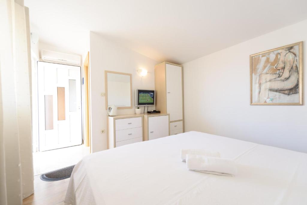 Postel nebo postele na pokoji v ubytování Apartments Kudelik