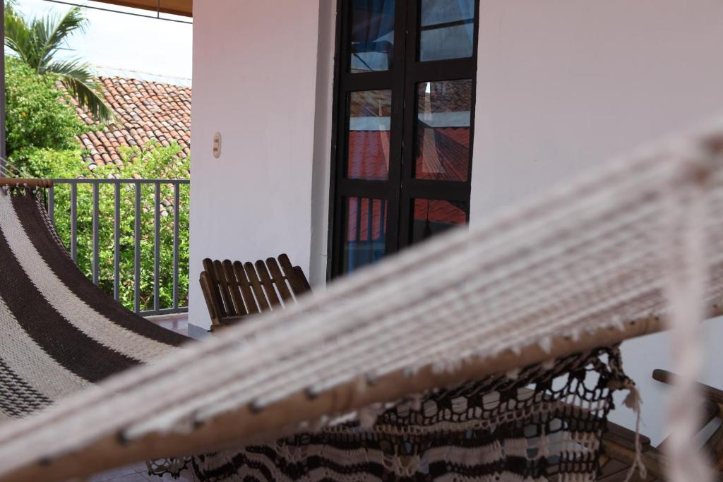 a hammock on the porch of a house at Hostal La Tortuga Booluda in León