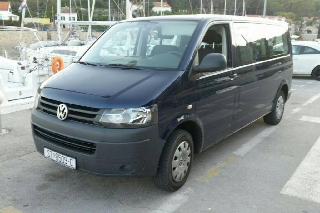 a van is parked in a parking lot at Villa Šolta in Rogač