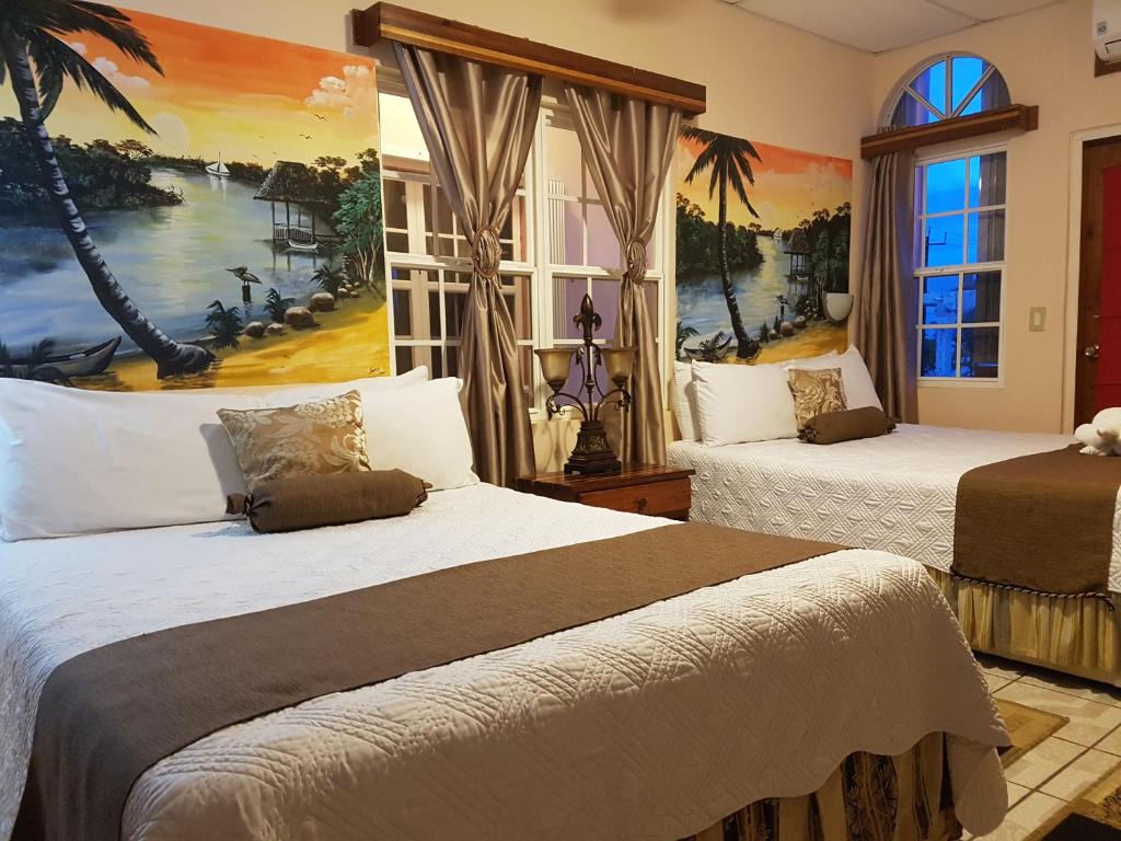 A bed or beds in a room at Beya Suites