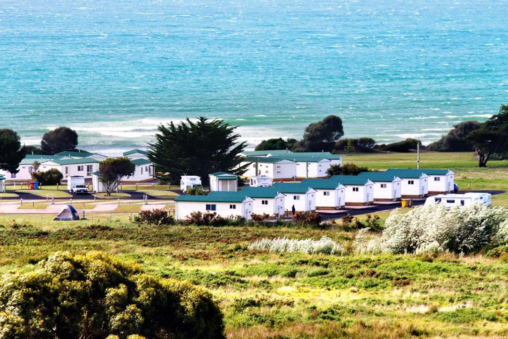 a row of houses on a hill next to the ocean at Discovery Parks - Devonport in Devonport