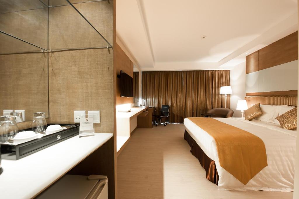 Кровать или кровати в номере Garden Sentral Hotel