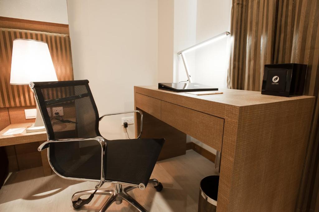 Телевизор и/или развлекательный центр в Garden Sentral Hotel