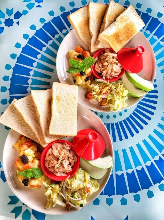 two plates of food on a blue plate at Raid Garden Boutique Hotel in Magong