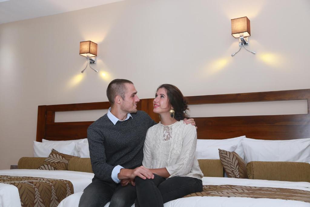 Postel nebo postele na pokoji v ubytování Rivendell Hotel