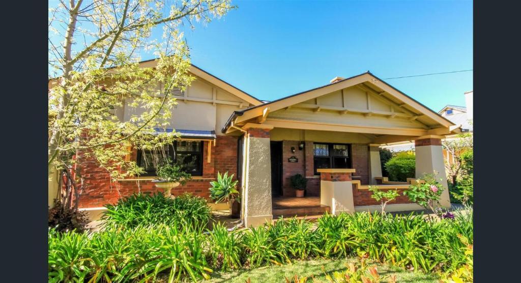 a home with a brick house with a porch at Ambrosia Holiday Home in Tanunda
