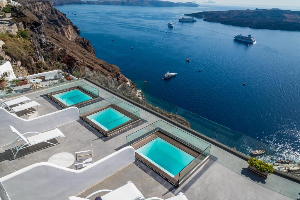 an image of a villa with a view of the ocean at Kratiras View Luxury Suites in Fira