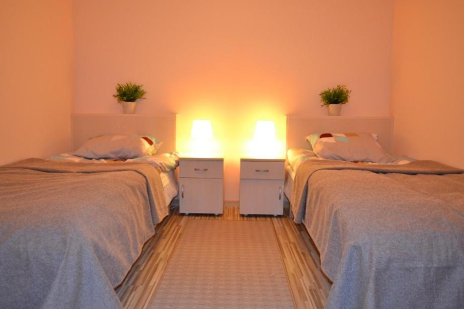 dwa łóżka w pokoju z dwoma światłami w obiekcie Hostel Gdańsk Sun and Sea w Gdańsku